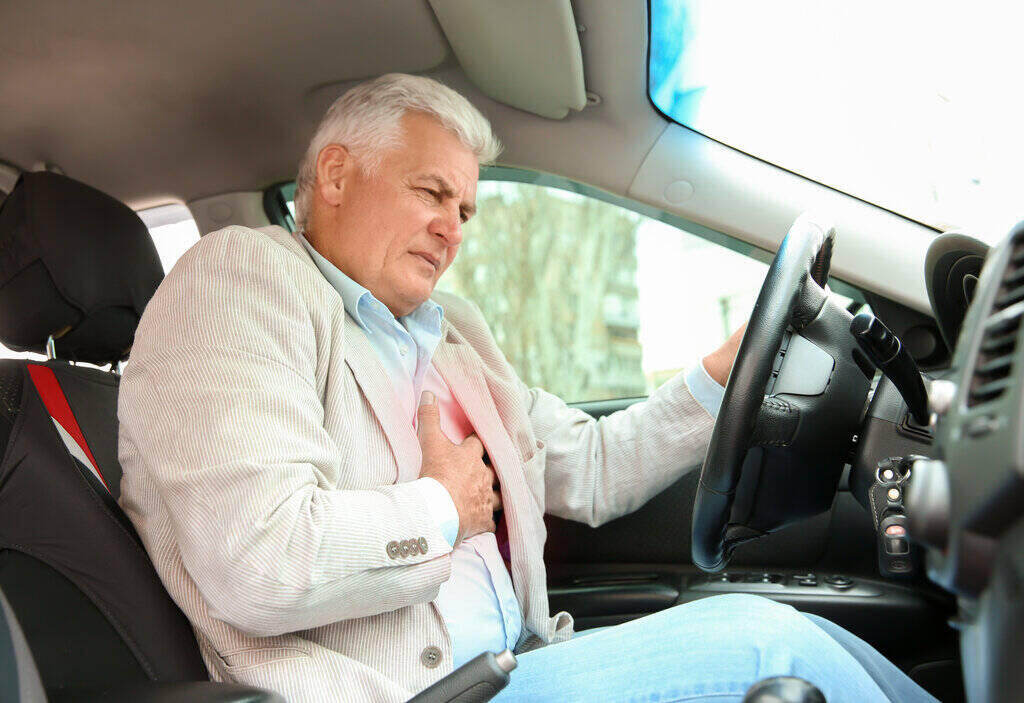 man having a heart stroke while driving